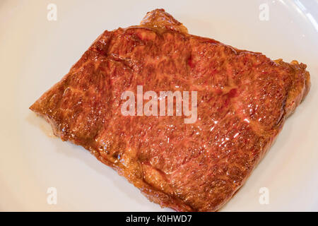 medium rare cooked Wagyu beef sit on a white plate Stock Photo