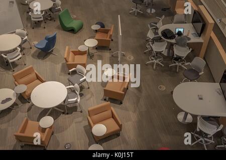 Aerial view of the Brody Learning Commons atrium with only one student sitting at a table, 2016. Courtesy Eric Chen. Stock Photo
