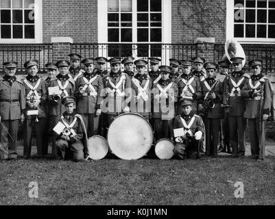 Group portrait of the Johns Hopkins University band, gathered outside a brick building in Baltimore, Maryland. November 16, 1946. Stock Photo