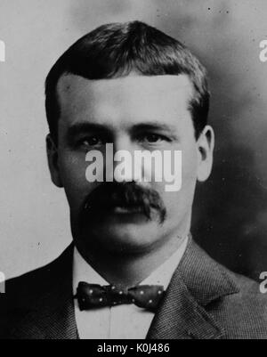 Head shot of original faculty member of Johns Hopkins University Medicine, John Miller Turpin Finney, wearing a dark suit and a dark polka-dotted bow tie with a white shirt, with a serious facial expression. 1902. Stock Photo