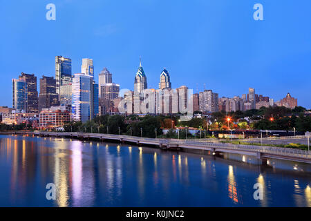 Philadelphia skyline illuminated and reflected into Schuylkill River at dusk, USA Stock Photo