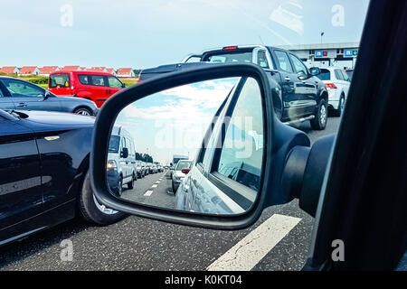 Traffic jam on a highway in the rearview mirror Stock Photo