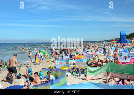Ustka, Poland - August 02, 2017: People lounging in the high season at the beach in Ustka - known tourist resort on the Baltic sea in Poland. Stock Photo