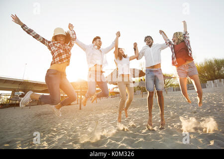 Group of friends on beach having fun Stock Photo