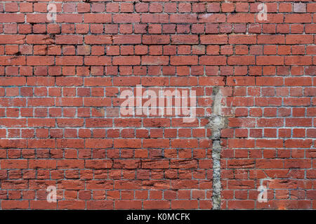Decaying grungy red brick wall texture background Stock Photo