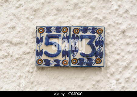 House number 53 ceramic sign on wall Stock Photo