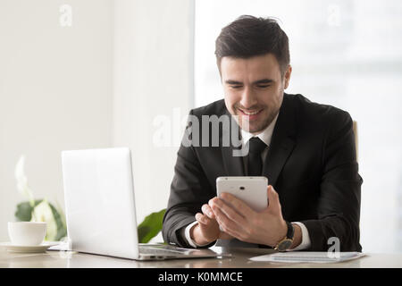 Happy smiling businessman using computer tablet, electronic devi Stock Photo