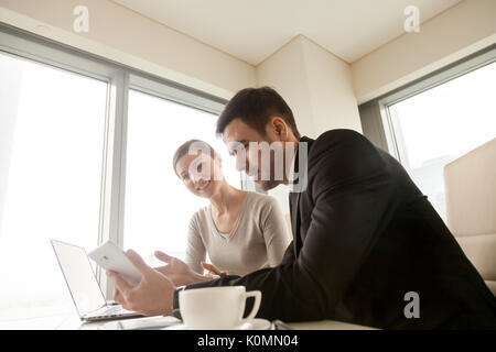 Businesspeople using tablet at office, mobile solutions for busi Stock Photo
