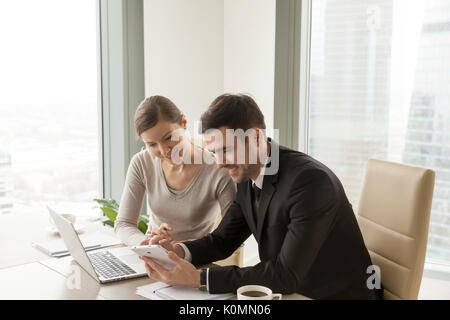 Office workers using digital tablet and laptop, mobile business  Stock Photo