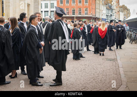 Students graduation UK, undergraduates assemble outside the Cambridge University Senate House prior to their graduation ceremony, England. Stock Photo