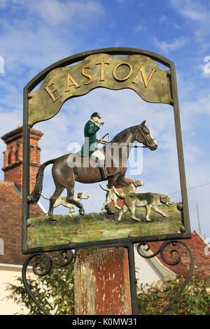 Village sign showing huntsman and harriers, Easton, Suffolk, England, UK Stock Photo