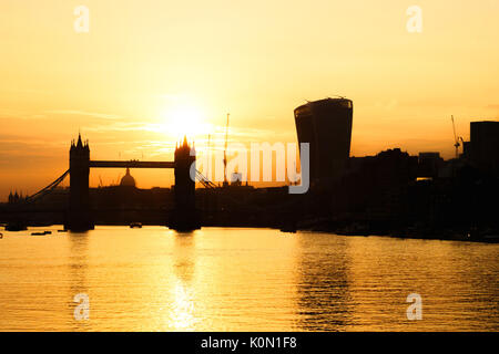 UK, London, Tower Bridge and the city skyline across River Thames at sunset, with view of St Paul's Cathedral and the Walkie Talkie tower