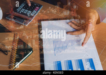 Double exposure of financial and offshore oil and gas platform background concept.  Hand business man work to calculate of finances or banking and acc Stock Photo