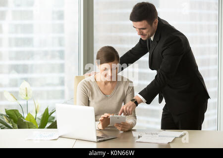 Smiling managers working on tablet, agents using real estate app Stock Photo