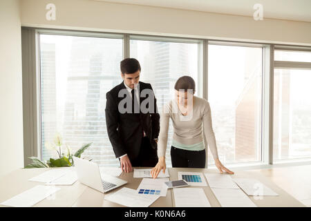 Creative interior designers sharing ideas, discussing color sche Stock Photo