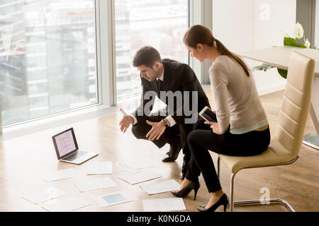 Businessman and businesswoman discussing interior design, planni Stock Photo