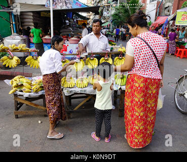 Yangon, Myanmar - Feb 13, 2017. A vendor selling banana at street market in Yangon, Myanmar. Yangon is the country largest city with a population abov Stock Photo