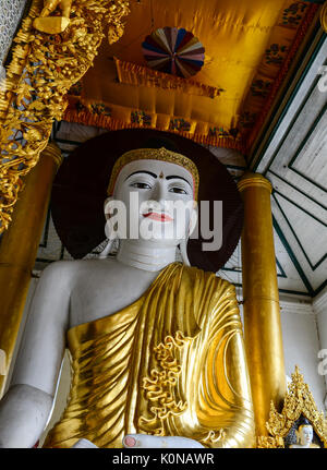 Yangon, Myanmar - Oct 1, 2011. Golden Buddha statue at main hall in Shwedagon Paya in Yangon, Myanmar. Shwedagon Pagoda is the most sacred Buddhist pa Stock Photo