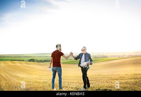 Senior father and his adult son with drone on a field Stock Photo - Alamy