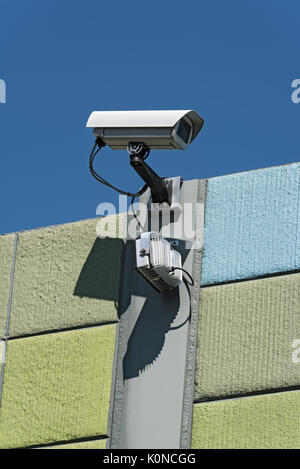 Security camera on a colorful wall with view on opposite sides Stock Photo