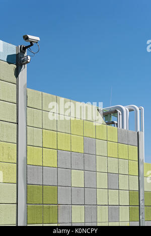 Security camera on a colorful wall with view on opposite sides Stock Photo