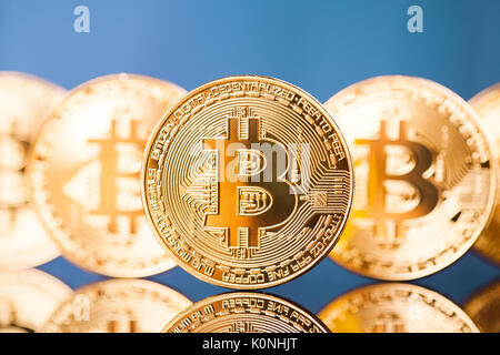 Five Virtual Coins Bitcoins On Blue Background Stock Photo