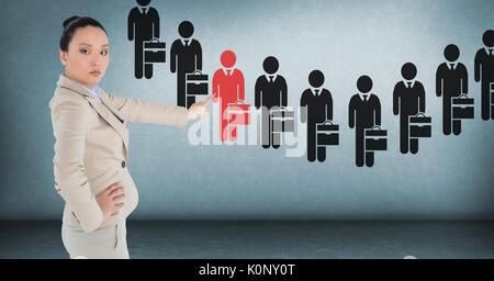 Digital composite of Businesswoman interacting and choosing a person from group of people icons Stock Photo