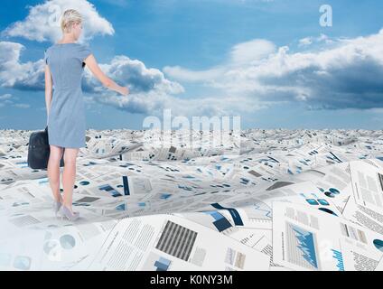 Digital composite of Businesswoman holding briefcase in sea of documents under sky clouds Stock Photo