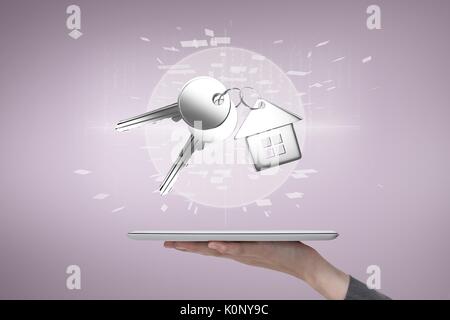 Digital composite of Person holding a tablet with keys Stock Photo