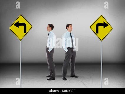 Digital composite of Left or right arrows on road signs with Businessman looking in opposite directions Stock Photo