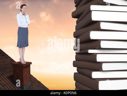Digital composite of Woman on roof looking at 3D books Stock Photo