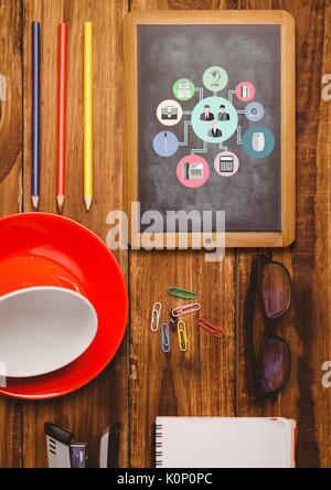Digital composite of Table top with a blackboard with web graphics Stock Photo