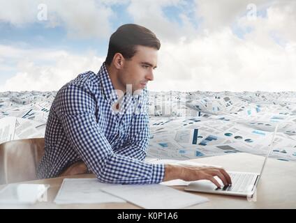 Digital composite of Businessman at desk in sea of documents under sky clouds Stock Photo