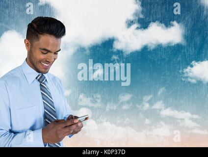 Digital composite of Businessman on phone under sky clouds Stock Photo