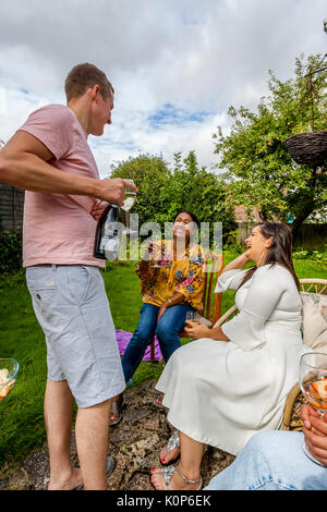 Family Members Laughing and Joking At A Family Barbecue, Sussex, UK Stock Photo