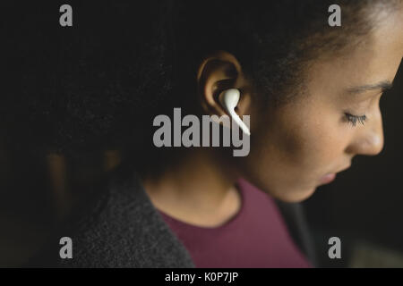 Beautiful woman listening to music at home Stock Photo