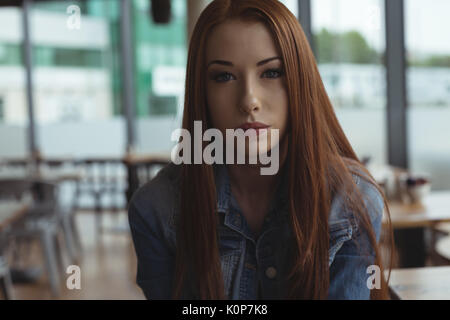 Portrait of young woman sitting in cafe Stock Photo