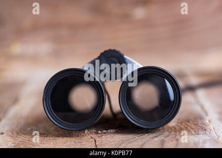 Binoculars on wooden background Stock Photo