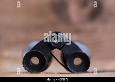 Binoculars on wooden background Stock Photo