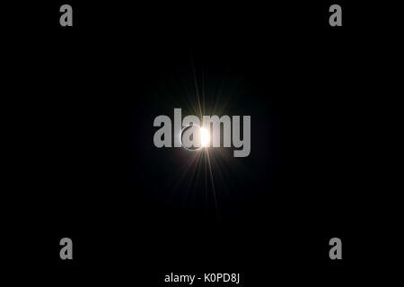 Total solar eclipse at the end of totality showing diamond ring effect against a dark black sky as seen from Colombia, SC on a summer afternoon Stock Photo