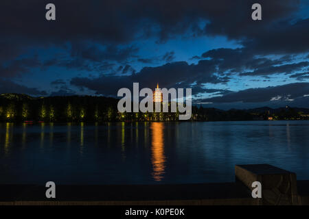 Chinese manual worker repairing the stone path, sidewalk in early evening Stock Photo