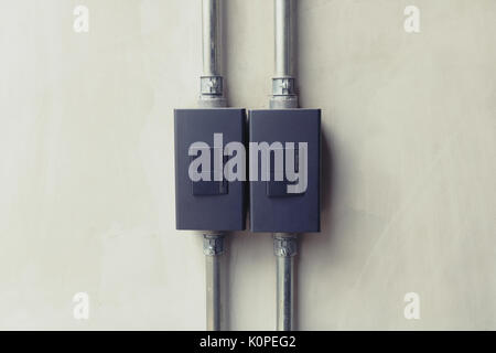 Close up of black lighting switch button on concrete wallpaper background with copy space. Stock Photo
