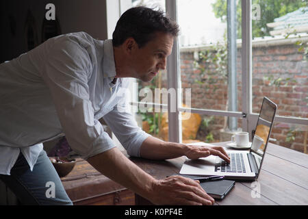 Man using his laptop in home office Stock Photo