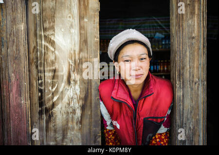 A Tibetan shopkeeper at her store in a remote village, in the Tibetan plateau Stock Photo