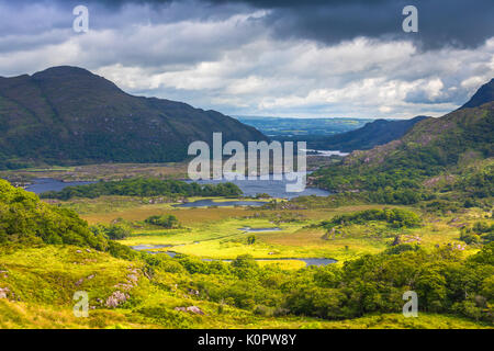 Ladies View is a scenic overlook along the N71 portion of the Ring of Kerry, in Killarney National Park, Ireland. The name apparently stems from the a Stock Photo