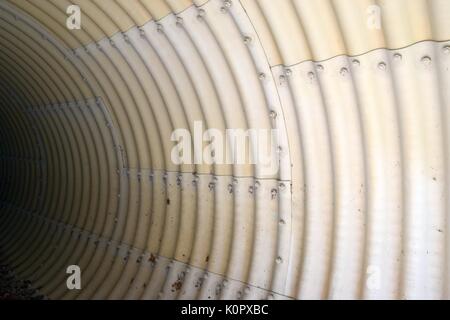 dirty and yellowed domed metal wall with nuts and pattern, metal sheets Stock Photo