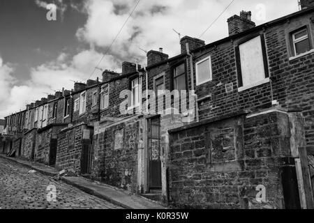 Millworkers' cottages on the back lane between Basil Street and Walton Street, Colne, Lancashire, England, UK: black and white version Stock Photo