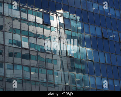 reflections of sunshine on blue tinted windows of glazed multi-storey office block in Sheffield, South Yorkshire, England, UK Stock Photo