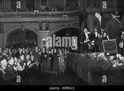 Wilhelm FURTWÄNGLER bowing  (on stage) & Hitler (in audience) clapping with his ministers during Third Reich. German conductor and composer 1886 - 1954.  Third Reich identifying with classical music culture. Stock Photo