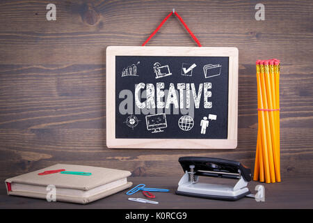 creative icon concept. Chalkboard on a wooden background. Stock Photo
